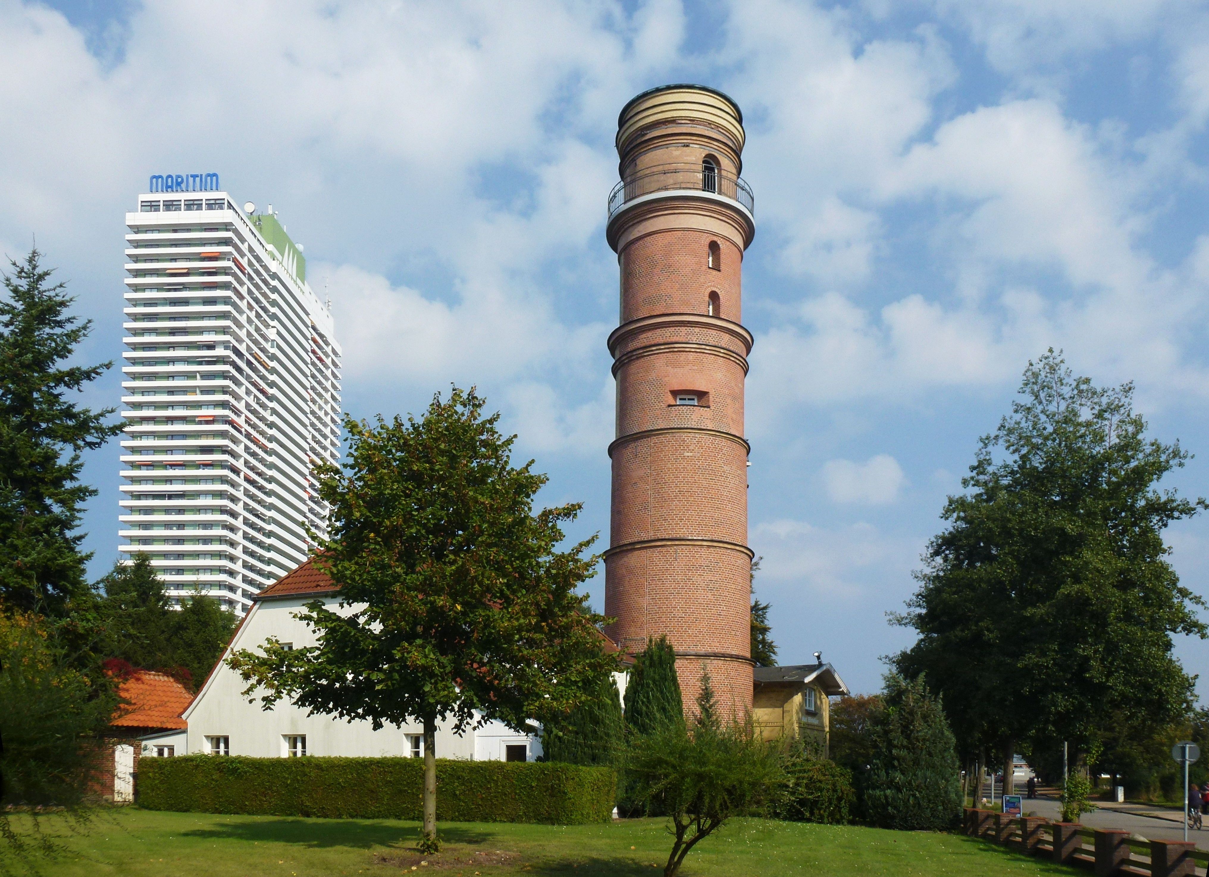 The brick-built Old Lighthouse of Travemünde with the Maritim high-rise behind it